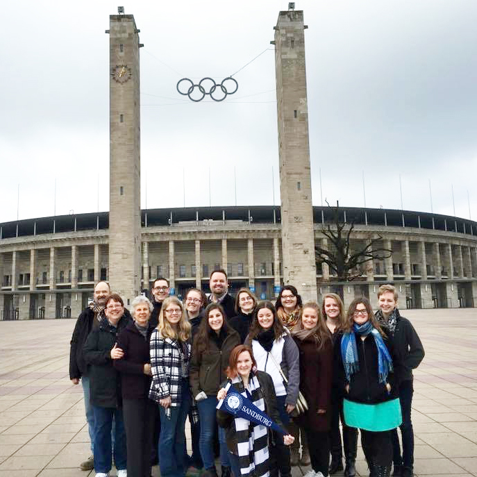 Group of students in front of an Olympic stadium aboard