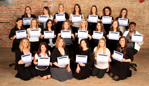 Dental Hygiene students holding their certificates.