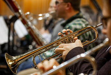Side view of a trumpet in a band.