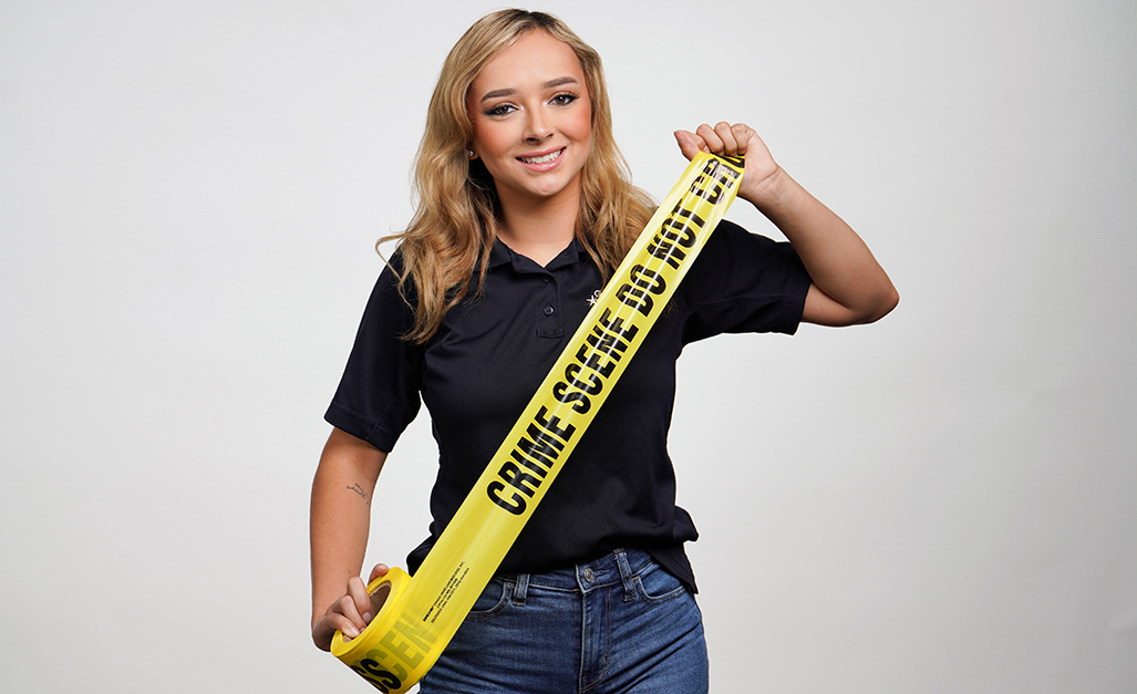 Corissa Wright portrait with her holding police tape