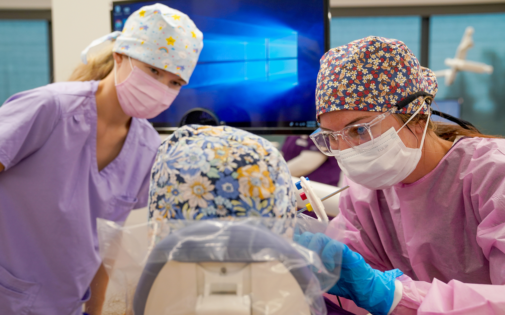 Students working on patient in dental hygiene clinic