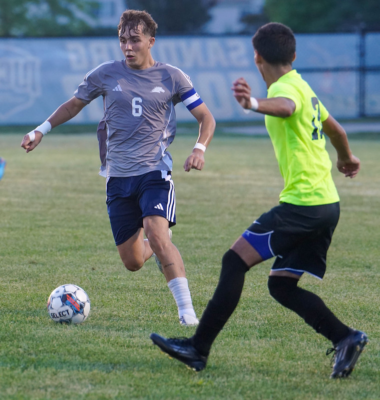 Alberto Fernandez Do Carmo playing dribbling soccer ball during game against Malcolm X.