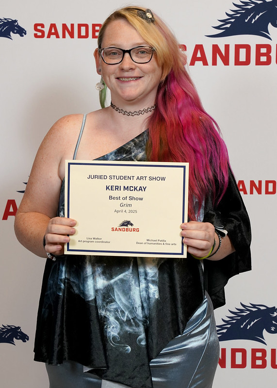 Keri McKay holds her Best of Show award from the 2025 Sandburg Student Art Show.