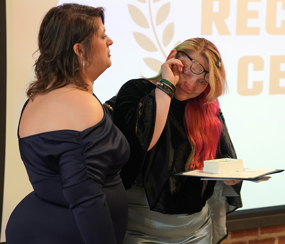 Keri McKay wipes away tears as she receives the 2025 Spirit of Sandburg Award.