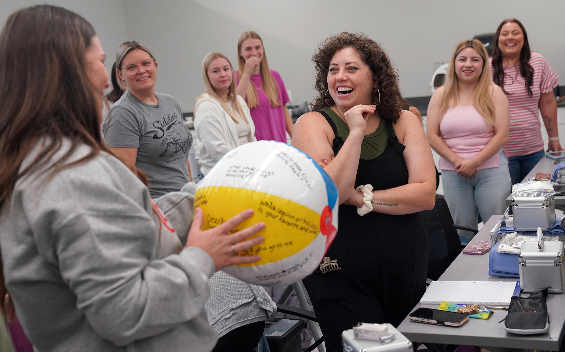 Students doing get-to-know-you icebreaker with beach ball.