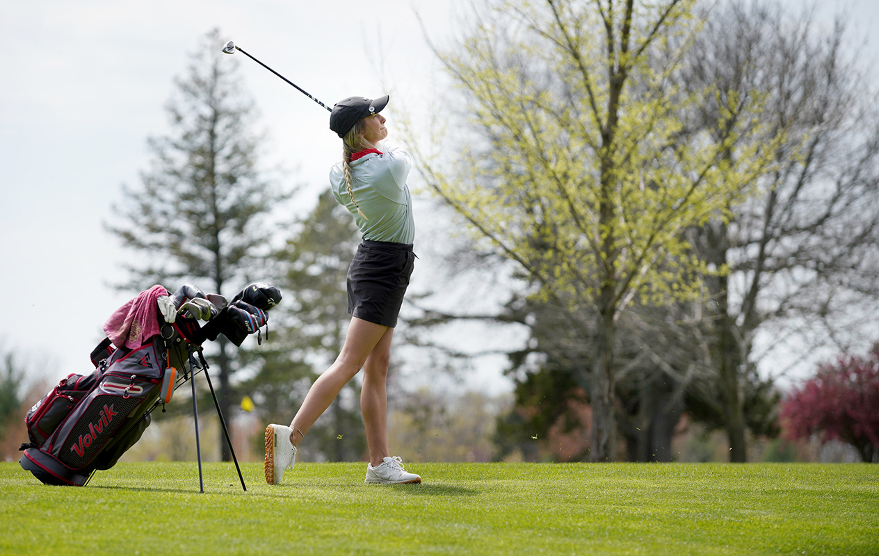 Women's golfer hitting shot