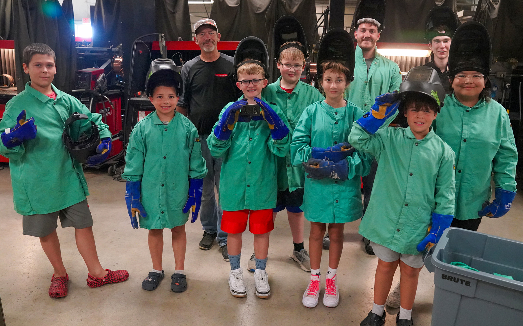 Kids on Campus participants wearing welding jackets and helmets