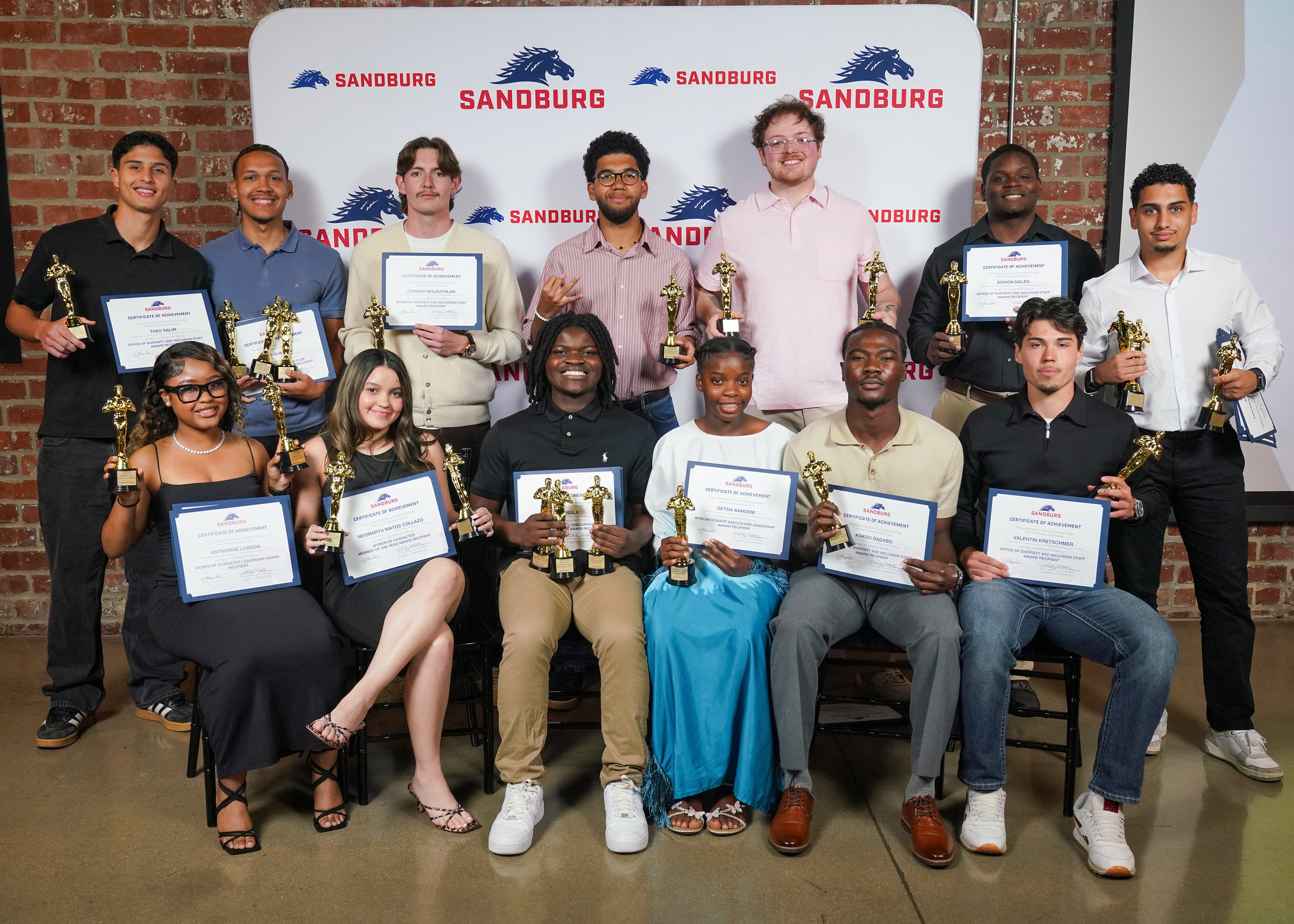 Students holding awards at event.