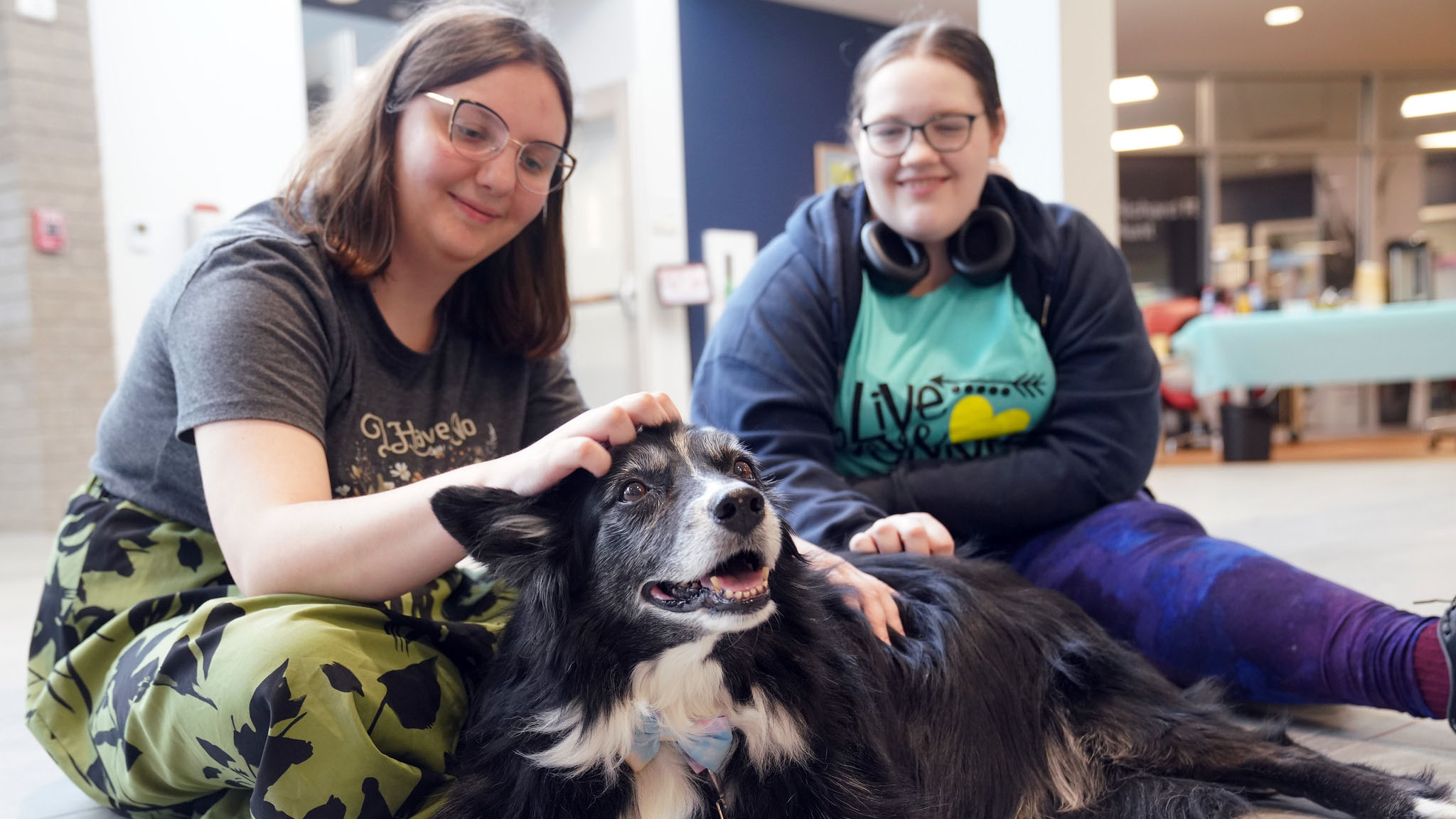 Students petting therapy dog.