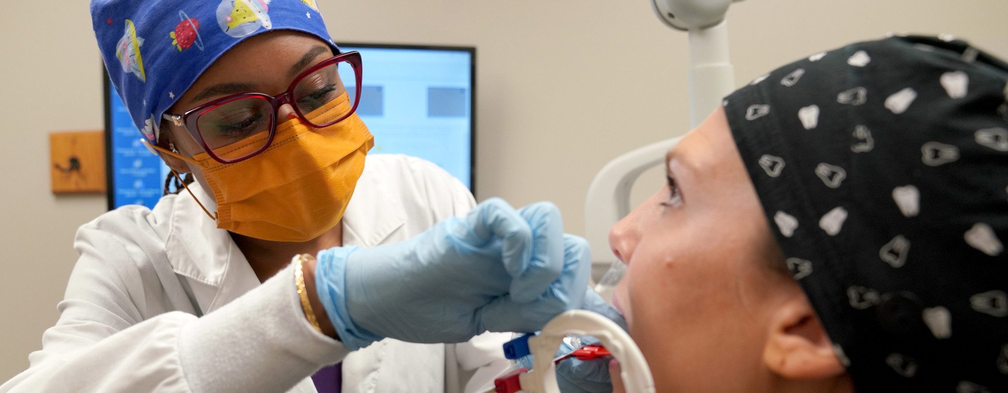 dental hygiene student taking an x-ray of patients mouth. 