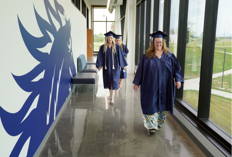 Sandburg graduates walking down the Science & Technology center hallway.