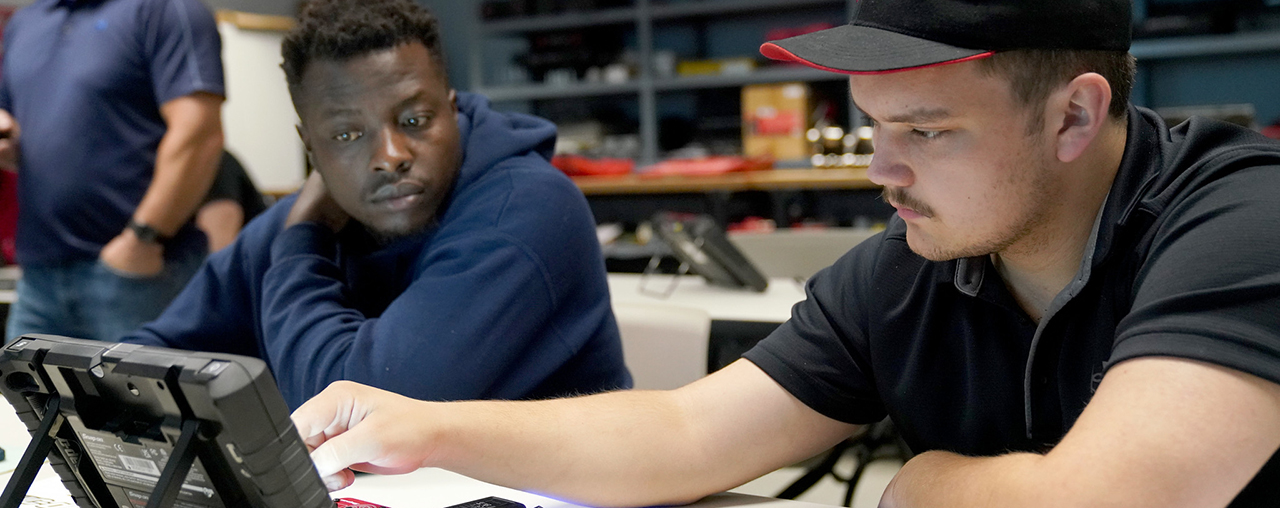 two students looking at a diagnosis tool.