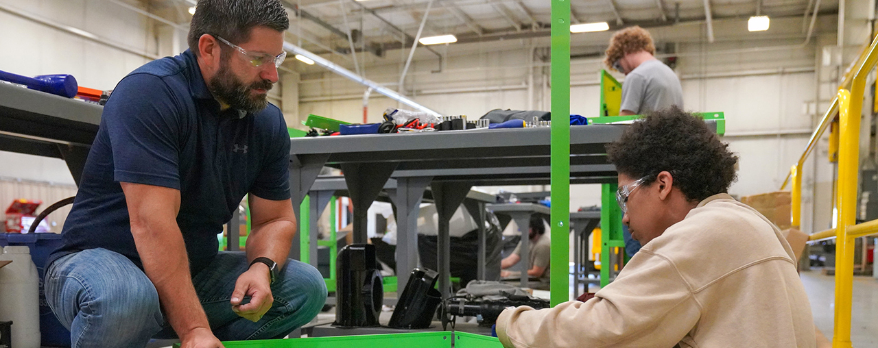 Instructor helping student put together a toolbox.