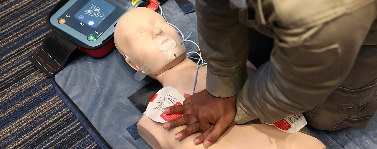Person preforming CPR on a mannequin.