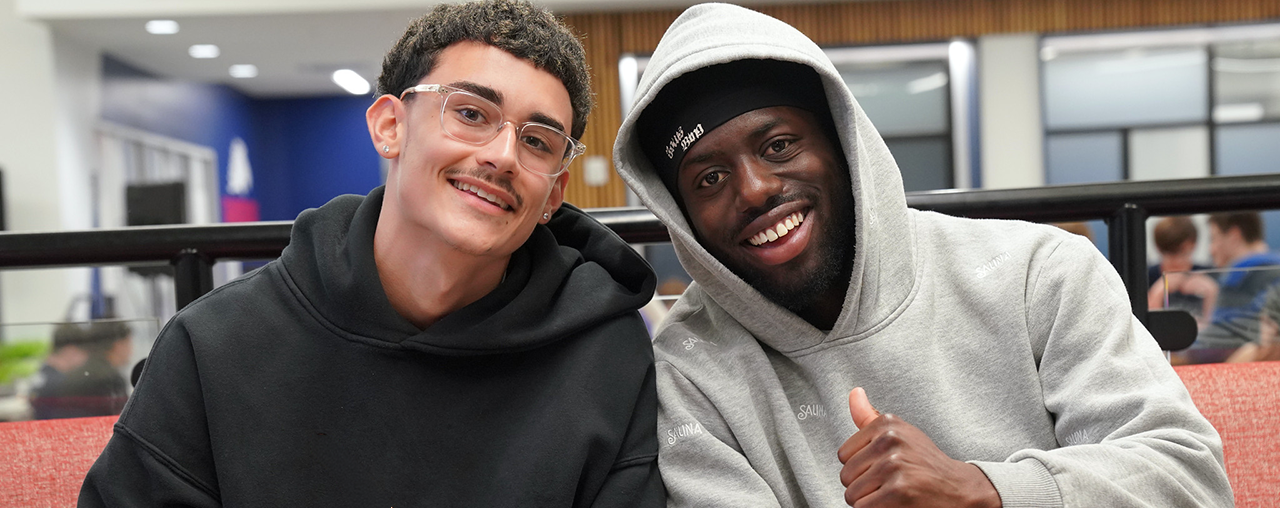 two students smiling at camera.