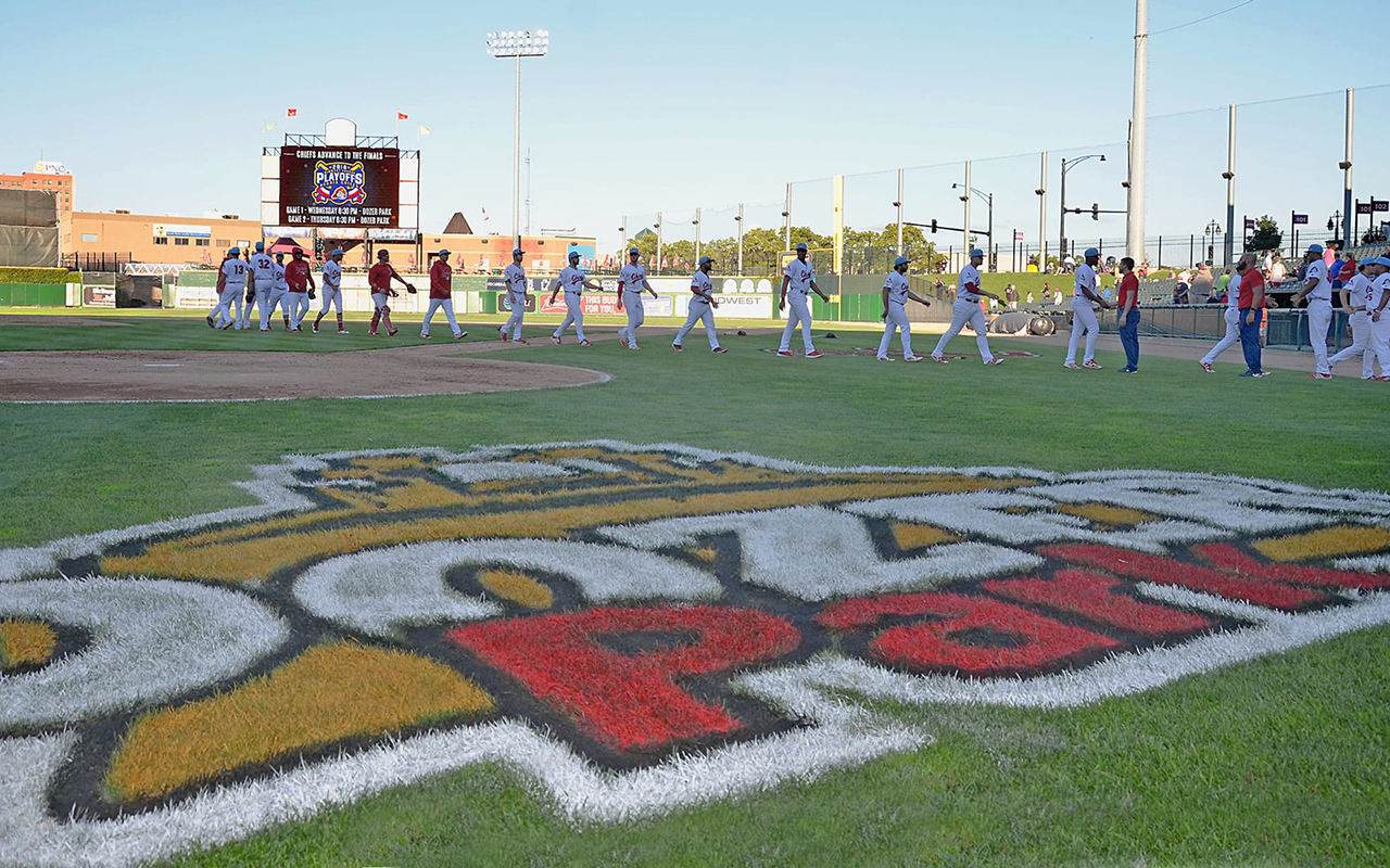 a baseball stadium full of people watching a game.