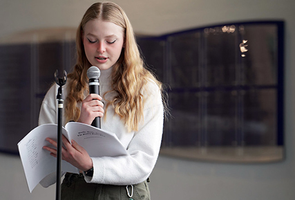 Female student reading a poem.