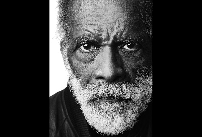 black and white image of a black man with a white beard.