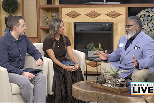 Anthony Law on KWQC set with two hosts.