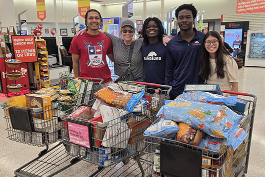 Students with grocery carts for food drive