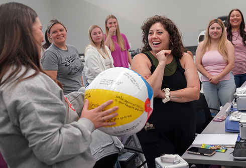 Dental hygiene students doing icebreaker activity with beach ball.