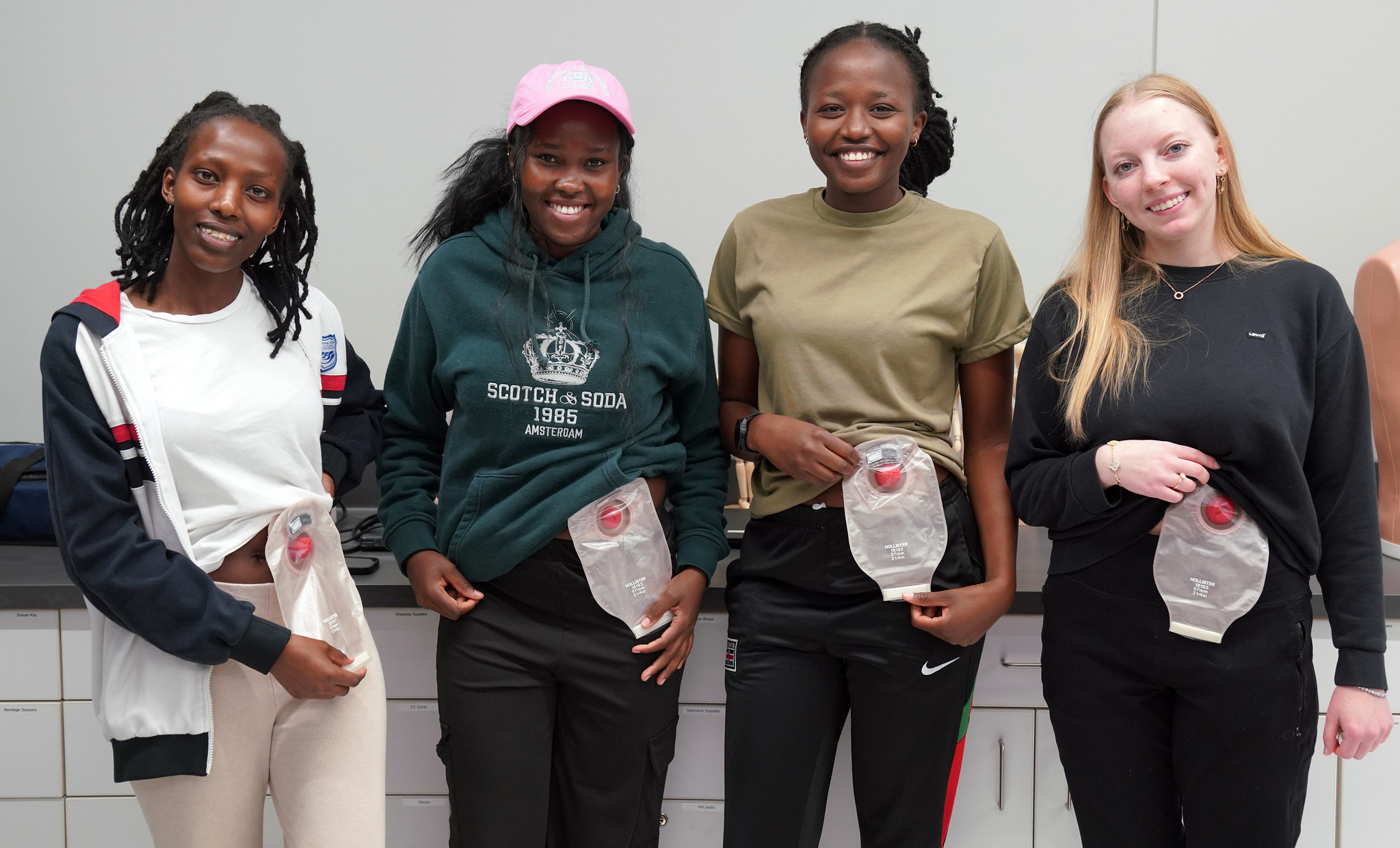 Nursing students wearing ostomy bags
