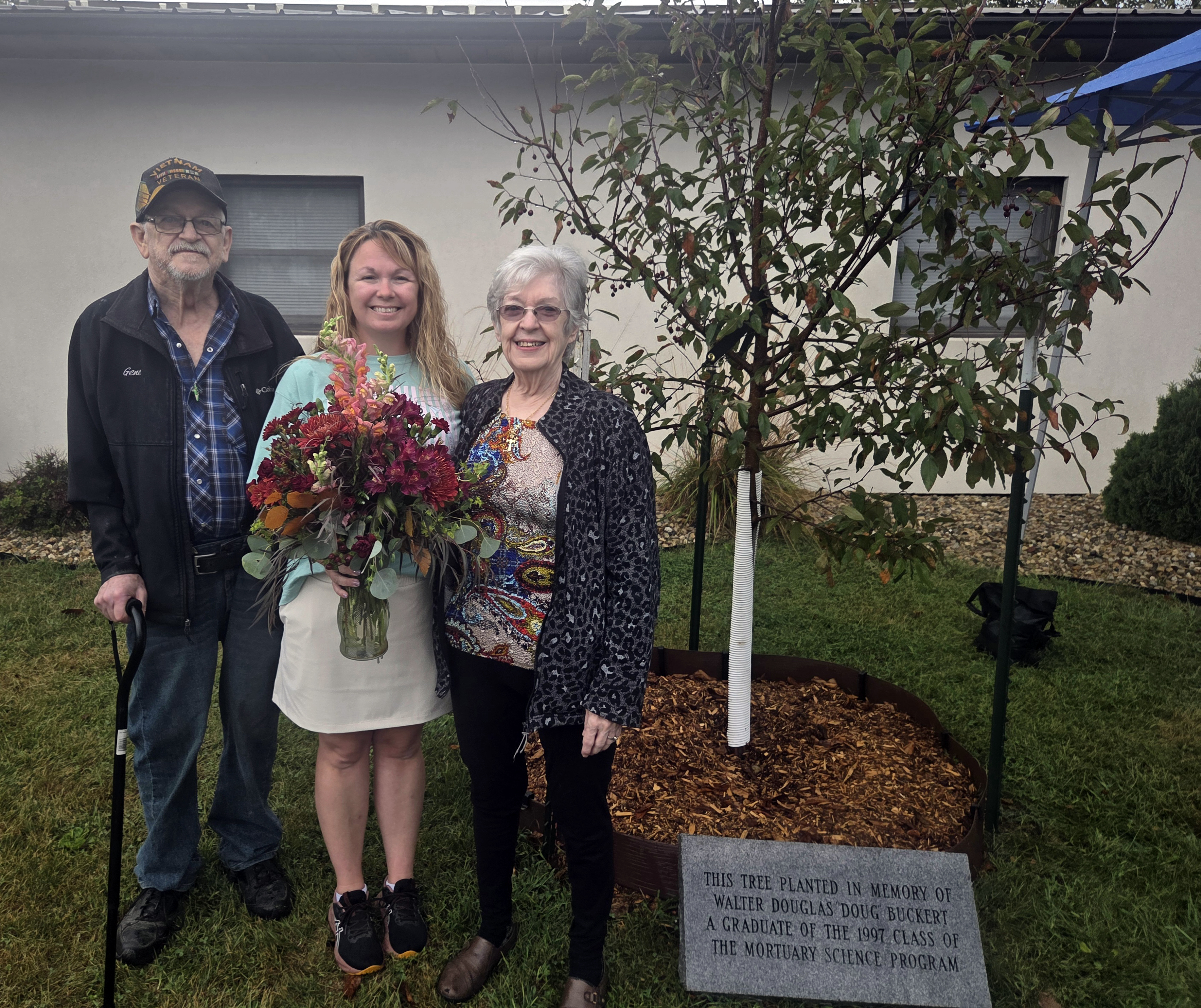 Buckert family next to tree.